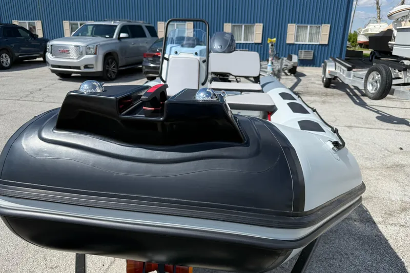 Slide: The Image of 2026 Zodiac Open 4.2 inflatable boat parked outdoors near vehicles. - 9