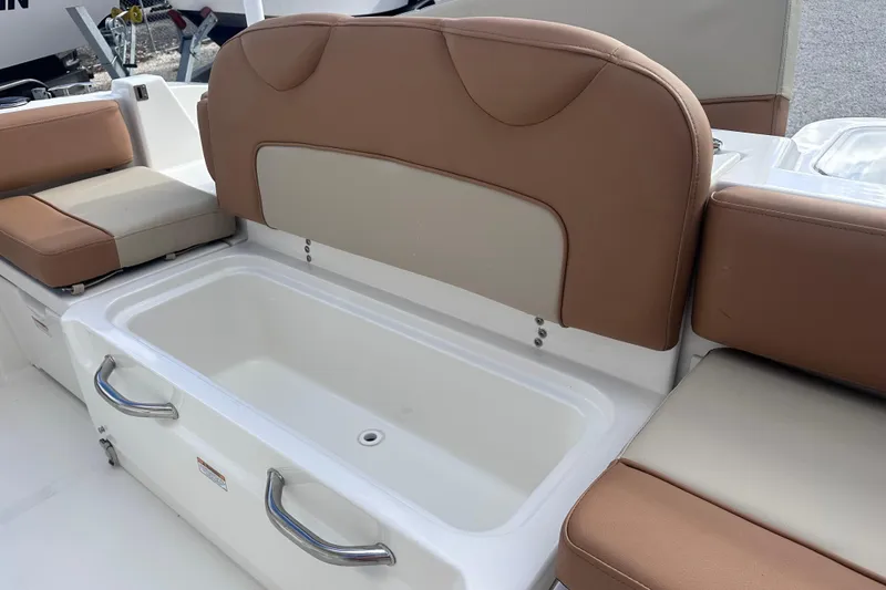 Slide: The Image of 2024 NauticStar 222L Offshore boat seating with storage compartment and cushioned seats. - 10