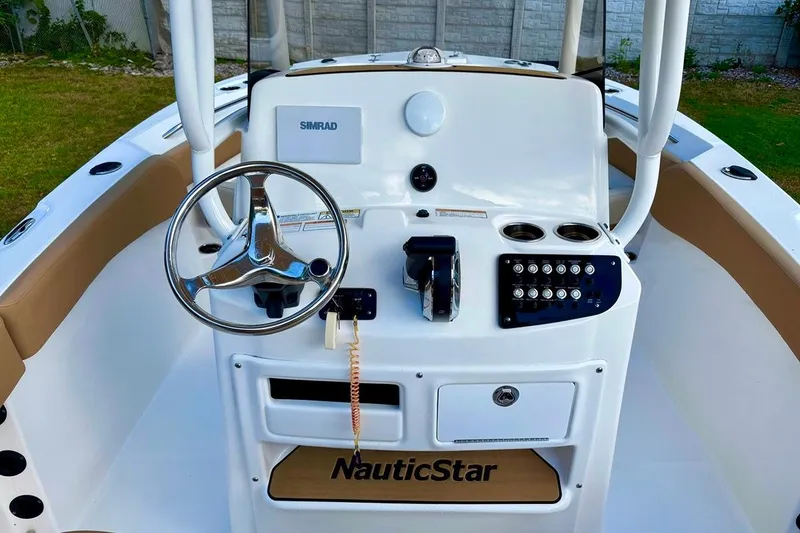 Slide: The Image of 2024 NauticStar 222L Offshore boat console with steering wheel and controls. - 4