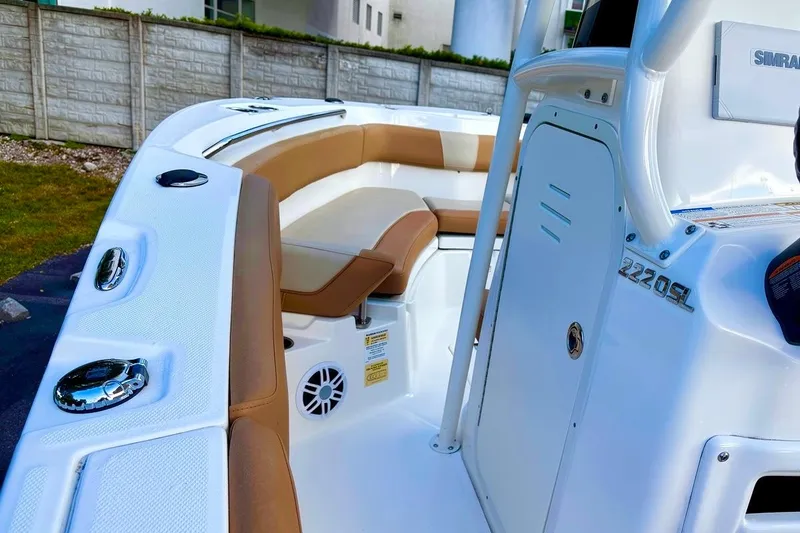Slide: The Image of 2024 NauticStar 222L Offshore boat interior with tan seating and white console. - 6