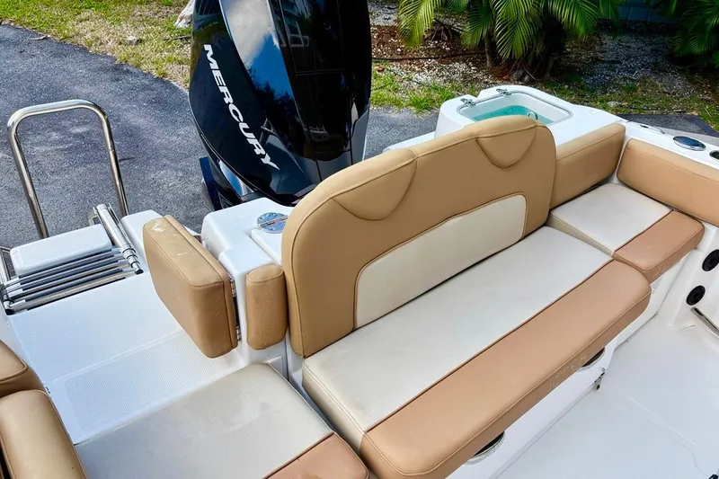 Slide: The Image of 2024 NauticStar 222L Offshore boat with tan seating and Mercury engine. - 7
