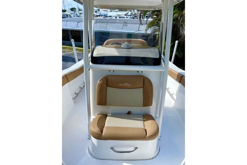 Slide: The Image of 2024 NauticStar 222L Offshore boat interior with tan seating and console. - 8