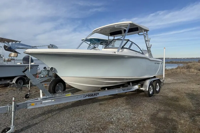 The Image of 2026 Key West 239 DFS boat on trailer by the shore under a clear sky. - 0