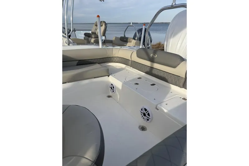Slide: The Image of 2026 Key West 239 DFS boat interior with seating and speakers by the water. - 4