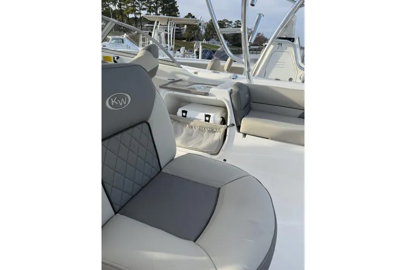 Slide: The Image of 2026 Key West 239 DFS boat interior with gray seating and storage compartments. - 5