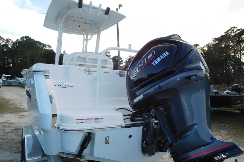 Slide: The Image of 2026 Robalo R230 Center Console boat with Yamaha engine, parked outdoors. - 3