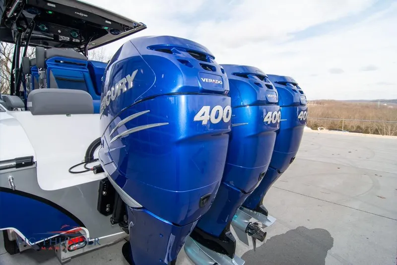 Slide: The Image of 2022 Fountain 38 SC boat on trailer, blue and white design, clear sky background. - 10