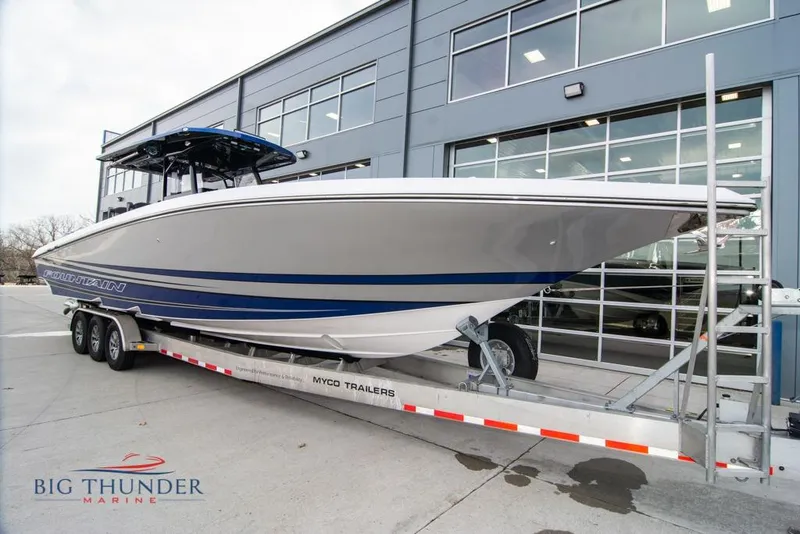 The Image of 2022 Fountain 38 SC boat on a lake with waterfront buildings in the background. - 2