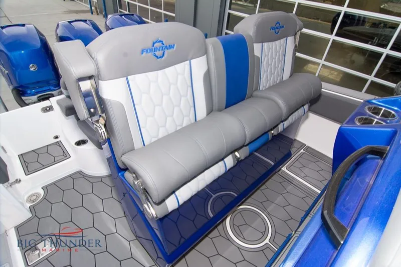 Slide: The Image of 2022 Fountain 38 SC boat cockpit with advanced navigation system and blue interior. - 25