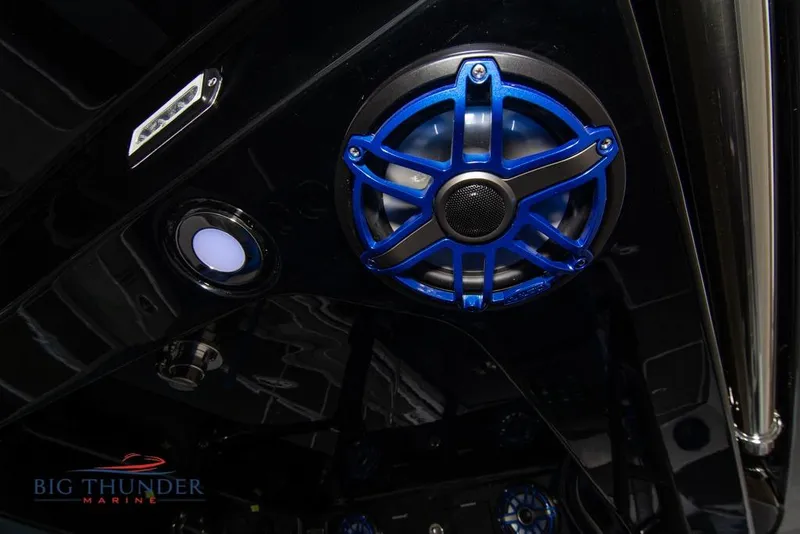 Slide: The Image of 2022 Fountain 38 SC boat interior with modern dashboard and seating, featuring blue accents. - 28