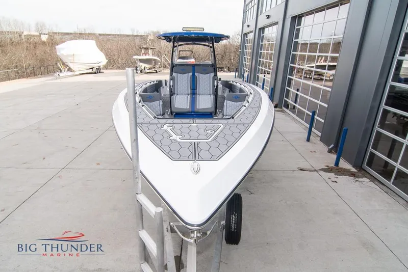 Slide: The Image of 2022 Fountain 38 SC boat cruising on a lake near waterfront buildings. - 4