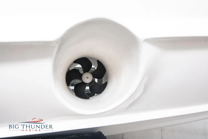 Slide: The Image of 2022 Fountain 38 SC boat cruising on a lake near waterfront buildings. - 5