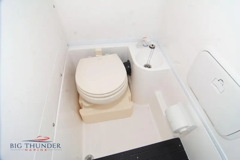 Slide: The Image of 2022 Fountain 38 SC boat interior with modern seating and illuminated controls in showroom. - 57