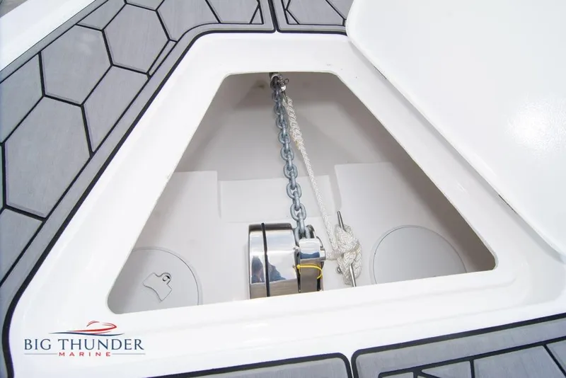 Slide: The Image of 2022 Fountain 38 SC boat interior with gray seating, blue LED lighting, and hexagonal flooring. - 64