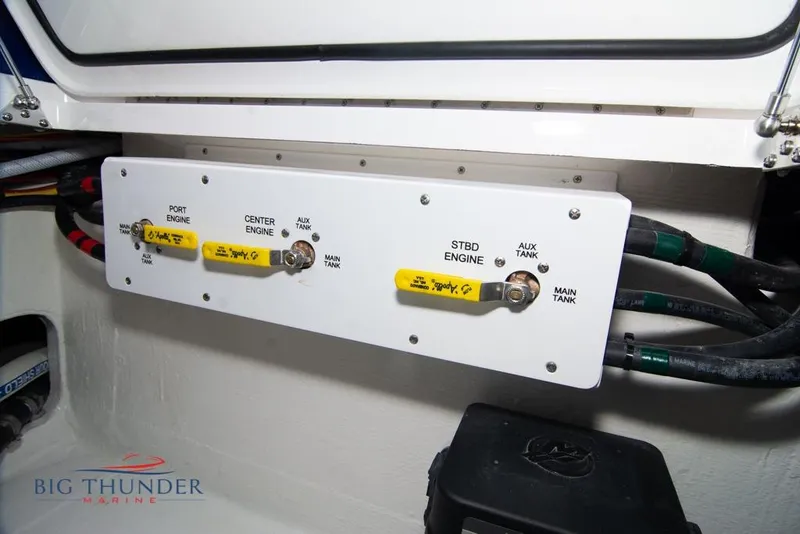 Slide: The Image of 2022 Fountain 38 SC boat interior with gray seating, blue lighting, and hexagonal flooring. - 66