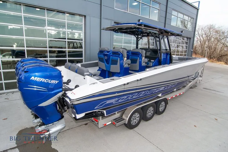 Slide: The Image of 2022 Fountain 38 SC boat with triple Mercury engines on a calm lake. - 7