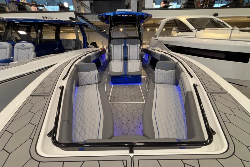 Slide: The Image of 2022 Fountain 38 SC boat interior with modern seating and ambient blue lighting. - 79