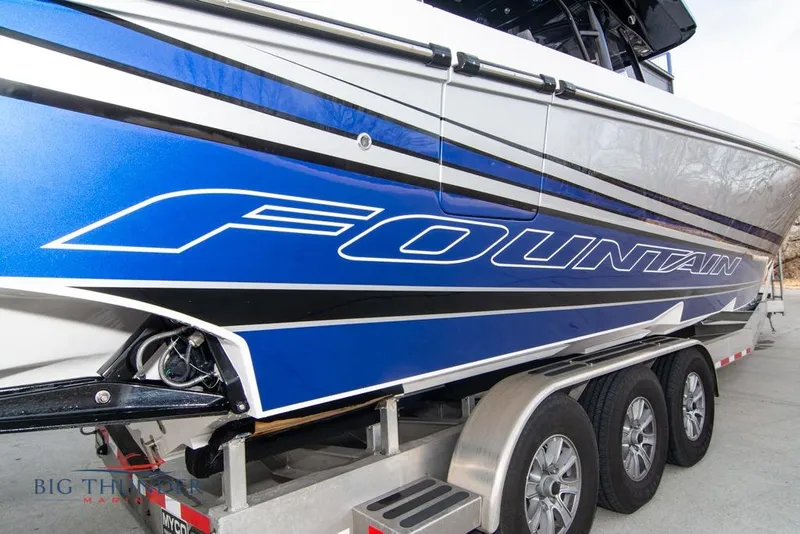 Slide: The Image of 2022 Fountain 38 SC boat docked under a covered marina. - 8
