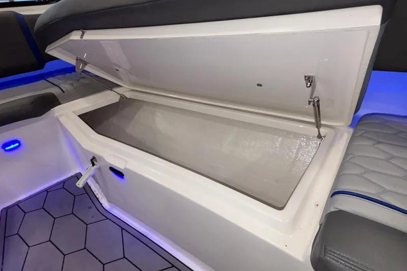 Slide: The Image of Open storage compartment in 2022 Fountain 38 SC boat with blue LED lighting. - 85