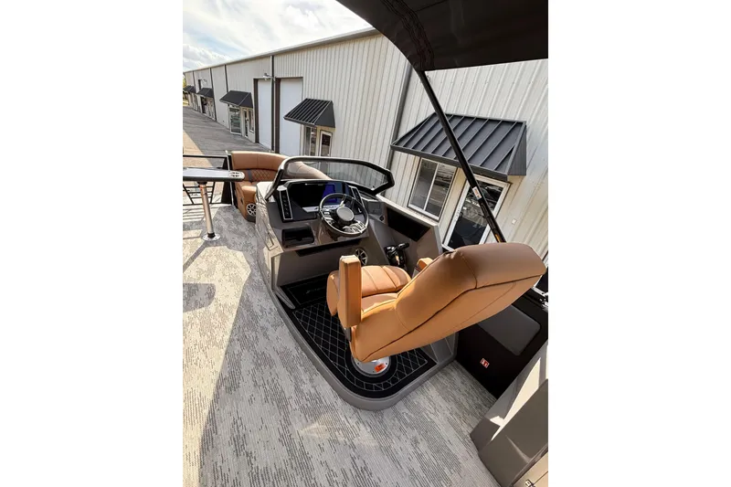 Slide: The Image of 2026 Starcraft RX 23 Q DH boat interior with tan seating and modern helm. - 11