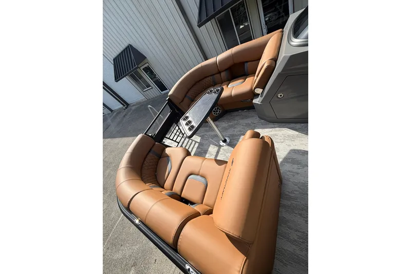 Slide: The Image of Luxurious seating on 2026 Starcraft RX 23 Q DH boat, featuring tan leather upholstery. - 12