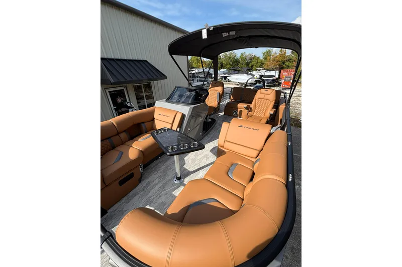 Slide: The Image of Luxurious 2026 Starcraft RX 23 Q DH pontoon boat with tan leather seating and sleek design. - 14