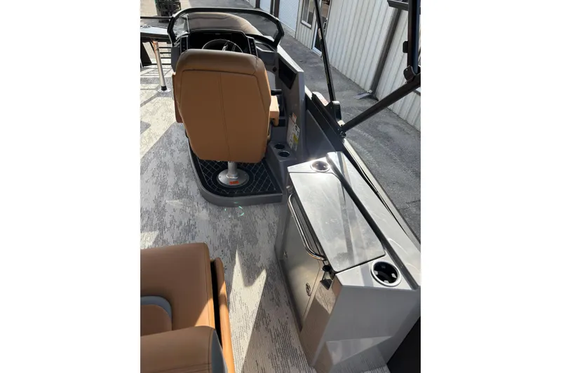 Slide: The Image of 2026 Starcraft RX 23 Q DH boat interior with helm and seating area. - 16