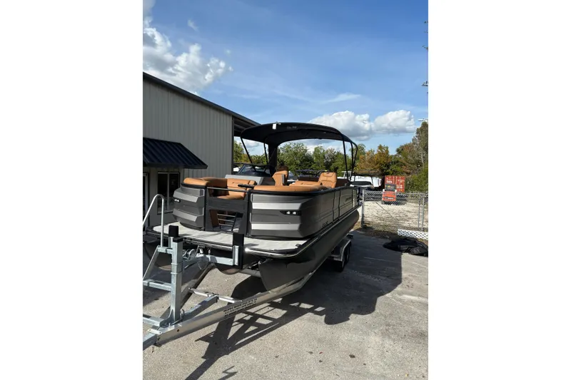 Slide: The Image of 2026 Starcraft RX 23 Q DH pontoon boat on trailer, outdoor setting. - 3