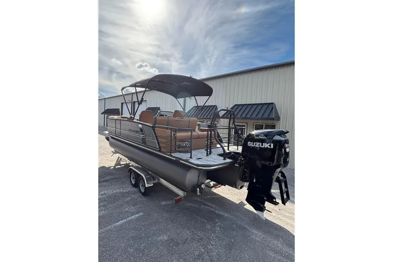 Slide: The Image of 2026 Starcraft RX 23 Q DH pontoon boat with Suzuki outboard motor on trailer. - 5