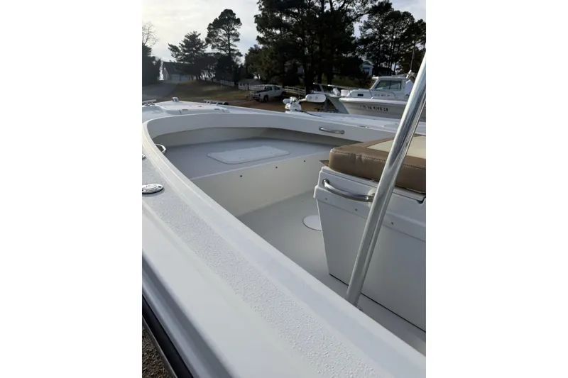Slide: The Image of 2017 Parker 1801 Center Console boat interior with seating and storage, docked outdoors. - 2