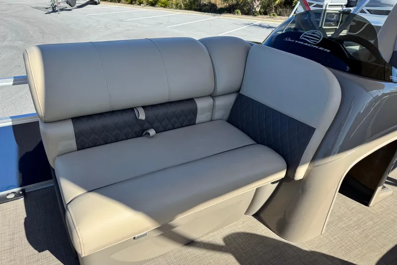 Slide: The Image of 2023 Sun Tracker Fishin' Barge 20 DLX, featuring comfortable beige seating and sleek design. - 13