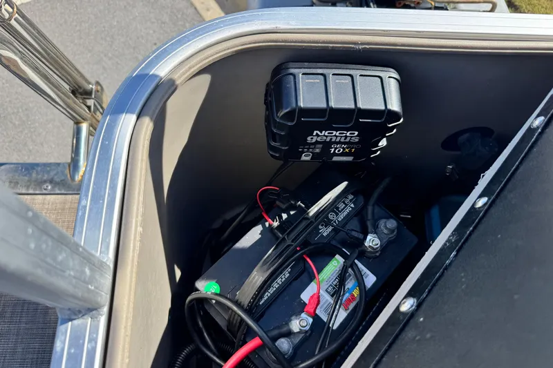 Slide: The Image of Battery compartment of 2023 Sun Tracker Fishin' Barge 20 DLX with NOCO Genius charger. - 20