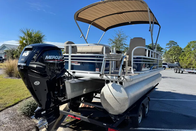 Slide: The Image of 2023 Sun Tracker Fishin' Barge 20 DLX pontoon boat with Mercury 90 engine, parked outdoors. - 5