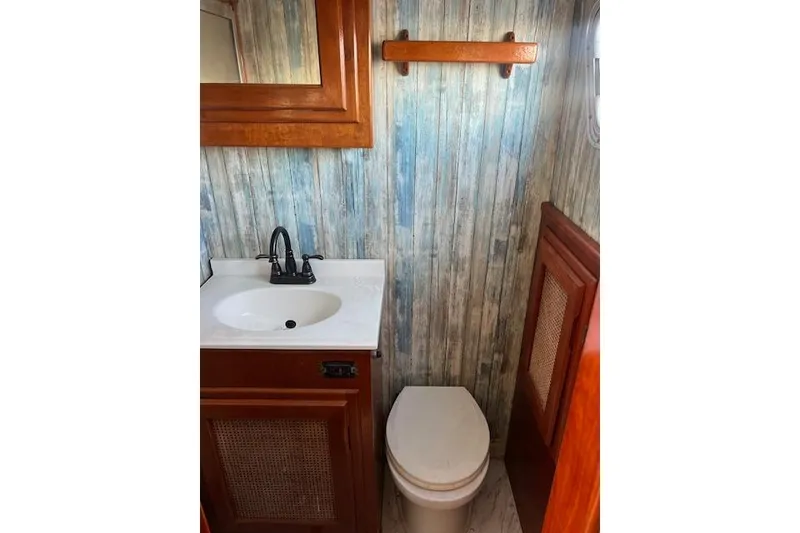 Slide: The Image of Vintage 1985 Sunnfjord 40 boat bathroom with wood accents and rustic decor. - 11