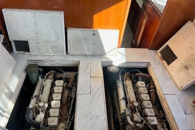 Slide: The Image of Engine room of 1985 Sunnfjord 40 boat with dual engines and open access panels. - 21