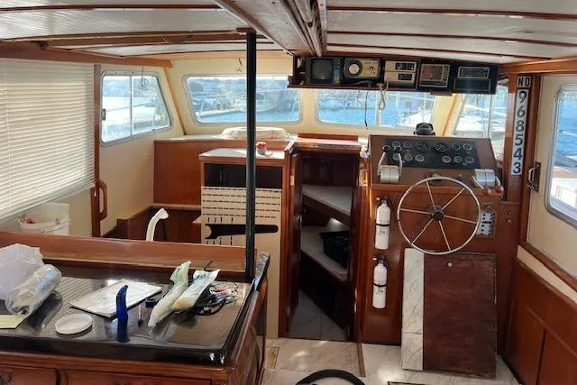 Slide: The Image of Interior of a 1985 Sunnfjord 40 boat with wooden helm and navigation equipment. - 22