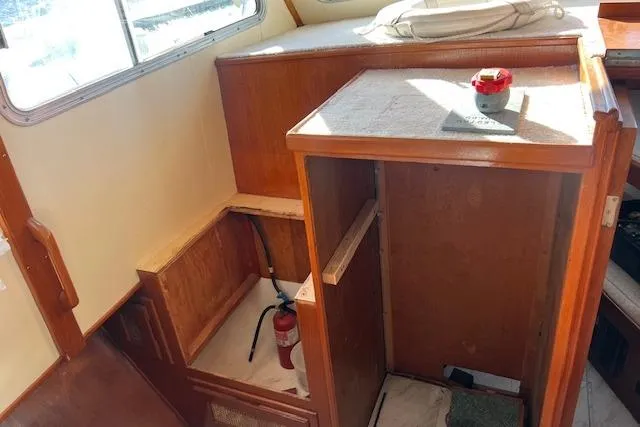 Slide: The Image of Interior of 1985 Sunnfjord 40 boat with wooden cabinetry and fire extinguisher. - 23