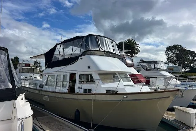 Slide: The Image of 1985 Sunnfjord 40 boat docked at marina under cloudy sky. - 25