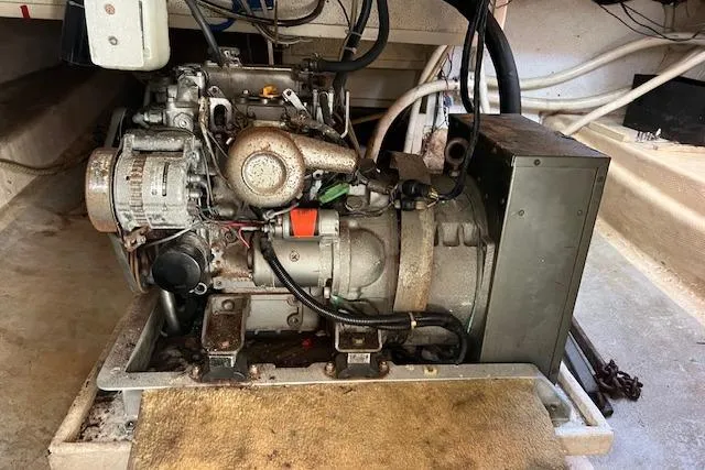 Slide: The Image of Engine compartment of a 1985 Sunnfjord 40 boat, showing mechanical components and wiring. - 27