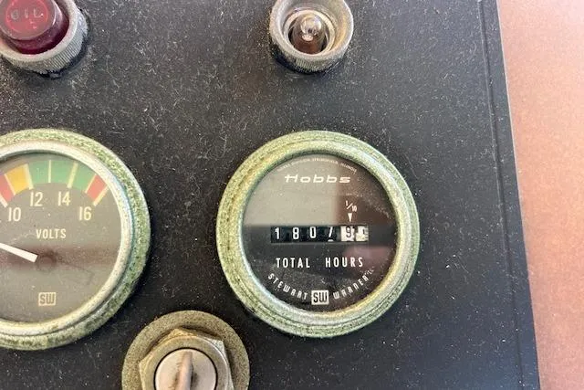 Slide: The Image of Vintage Sunnfjord 40 dashboard with voltmeter and Hobbs hour meter, showing 1807.5 hours. - 5