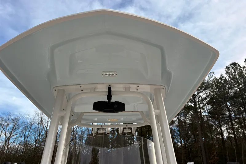 Slide: The Image of 2023 Robalo R230 Center Console boat with T-top against a clear sky. - 10