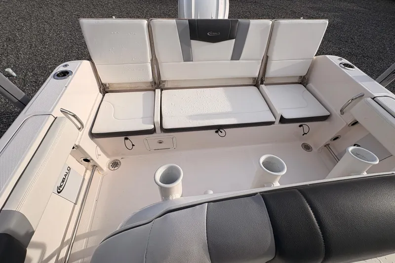 Slide: The Image of 2023 Robalo R230 Center Console boat interior with seating and rod holders. - 13