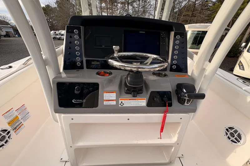 Slide: The Image of 2023 Robalo R230 Center Console boat dashboard with steering wheel and controls. - 15