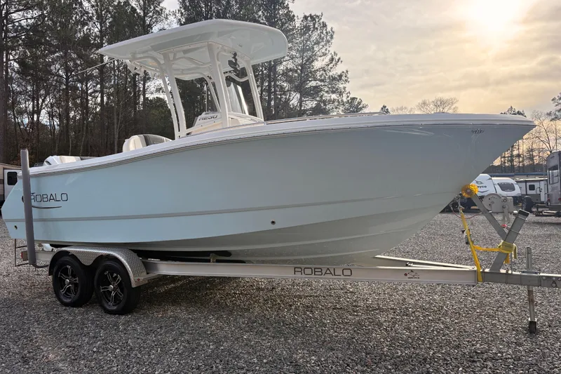 Slide: The Image of 2023 Robalo R230 Center Console boat on trailer, parked outdoors. - 5