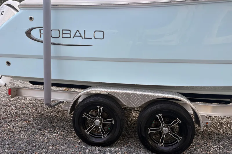 Slide: The Image of 2023 Robalo R230 Center Console boat on trailer, side view. - 6