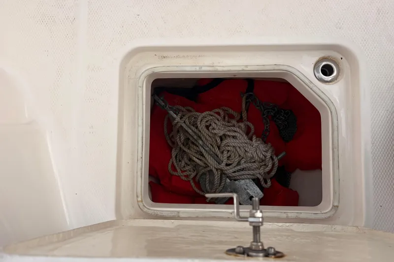Slide: The Image of Storage compartment on 2023 Robalo R230 Center Console with rope and anchor. - 9