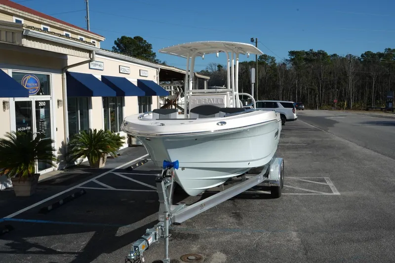 Slide: The Image of 2026 Robalo R202 Explorer boat on trailer outside dealership. - 3