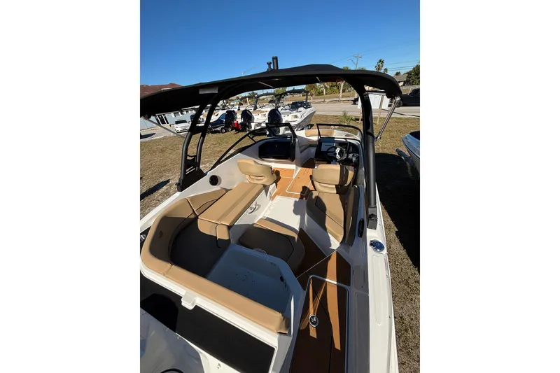 Slide: The Image of 2026 Bayliner V20 boat interior with tan seating and modern dashboard. - 10