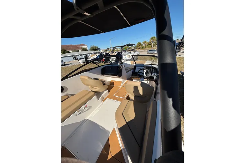 Slide: The Image of 2026 Bayliner V20 boat interior with tan seating and modern dashboard. - 16