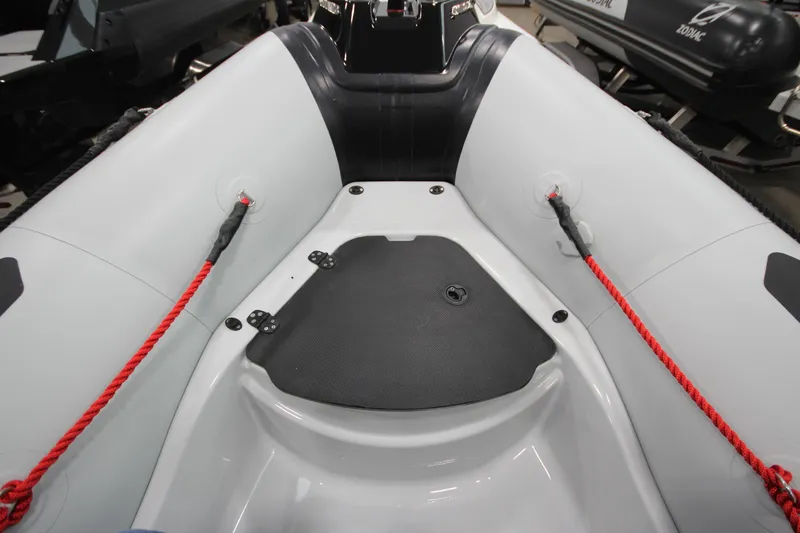 Slide: The Image of 2026 Zodiac Open 4.2 inflatable boat interior with red ropes and black seating. - 17